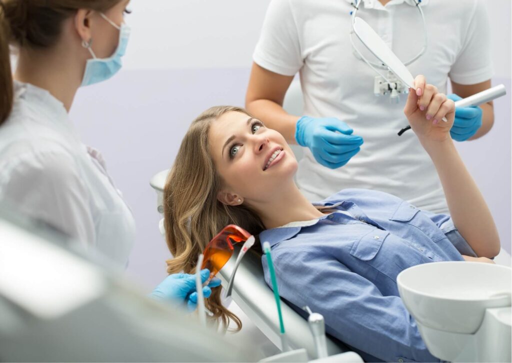 Patient discussing cosmetic treatment options with a dentist while deciding between dental bonding and veneers.