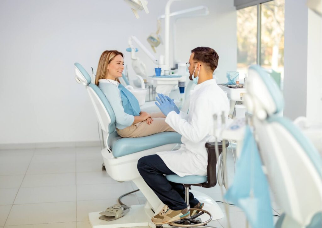 Dentist consulting with a patient about treatment options and factors that affect dental implant costs.