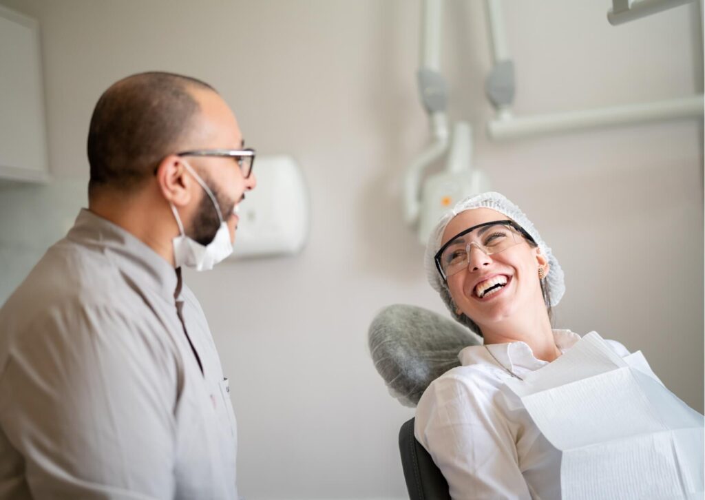 Dentist discussing MRI scan considerations with a patient who has dental implants before medical imaging.